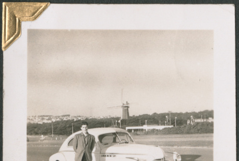 Man standing next to car on side of road (ddr-densho-434-138)