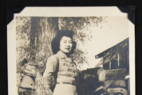 Nori by a wood stack (ddr-densho-542-606)