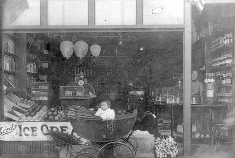 Baby in front of grocery store (ddr-densho-105-2)