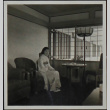 A woman seated in the Travel Room at the Golden Gate International Exposition (ddr-densho-300-384)