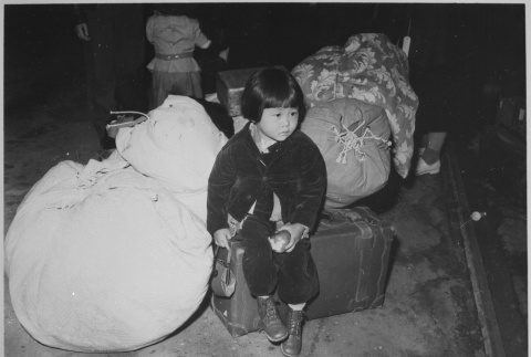 Child waiting with baggage (ddr-densho-37-436)