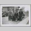 Family standing in front of a car (ddr-densho-201-850)