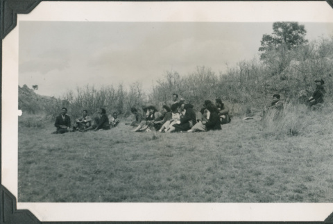 Photo of people lying on a grassy hill (ddr-densho-483-1357)