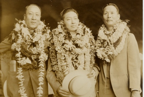Three men posing with leis (ddr-njpa-1-3)