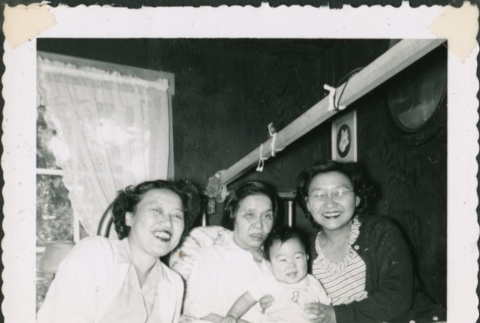 Three women in bed with a baby (ddr-densho-321-273)
