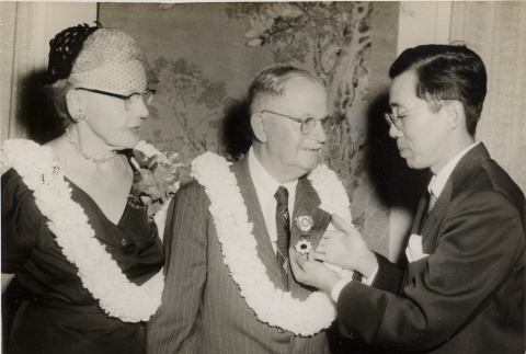 Man receiving a medal, standing next to wife (ddr-njpa-2-774)