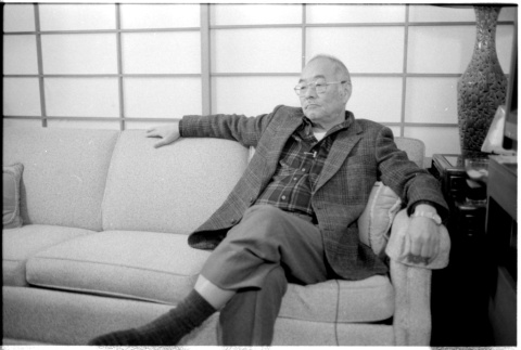 John Fujii on sofa (ddr-densho-1007-1175)