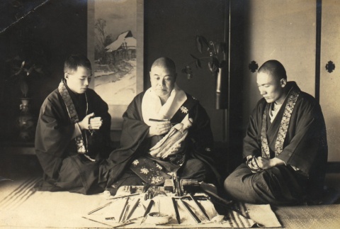 A Kona Hongwanji priest carving a sculpture with two others (ddr-njpa-4-1635)