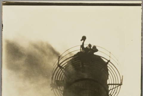 A man waving from the top of a smokestack (ddr-njpa-13-1448)