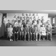 Group photograph with men and women inside an office barracks (ddr-fom-1-446)