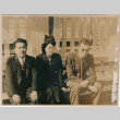 Tomoye (Nozawa) Takahashi seated on bench with two men (ddr-densho-426-1482)