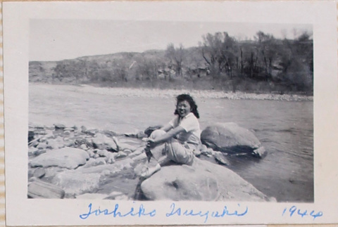 Woman sitting by river (ddr-densho-464-29)