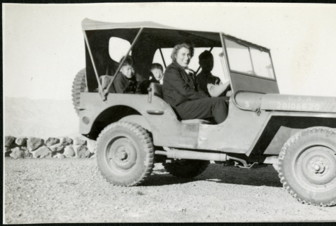 Death Valley, Cow Creek Camp. Josephine Hawes riding in a Jeep with children (ddr-densho-343-15)