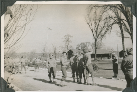 Groups of men standing on road by camp buildings (ddr-ajah-2-442)