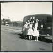 Photograph of four women standing in front of a U.S. Army ambulance at Manzanar (ddr-csujad-47-183)