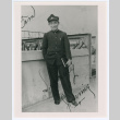 Person in uniform holding book (ddr-densho-1007-29)