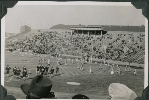 Football game in stadium with crowd in bleachers (ddr-ajah-2-515)