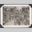 Group of men standing on dock looking up at ship (ddr-densho-466-156)