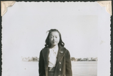 Adolescent girl standing by a lake (ddr-densho-321-204)