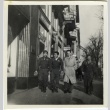 Soldiers and civilian on commercial street (ddr-densho-201-159)