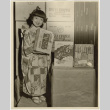 Young girl in kimono posing with Umeya products (ddr-densho-499-178)