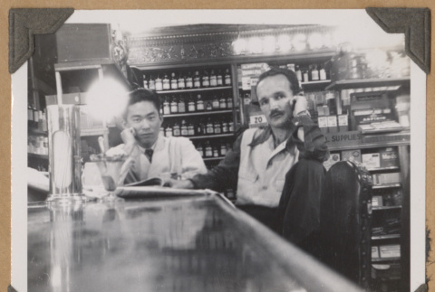 Gary and another man sitting at a counter (ddr-densho-542-66)