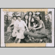 Seven women sitting on a log (ddr-densho-483-1075)