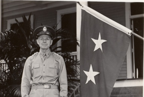 Walter C. Short standing near a flag (ddr-njpa-1-1910)