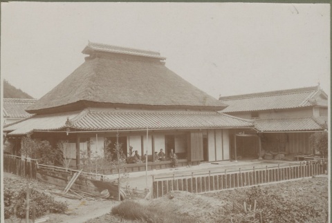 Family sitting on porch of Japanese-style house (ddr-densho-332-41)