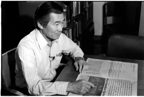 Frank S. Emi with newspaper (ddr-densho-1007-1163)