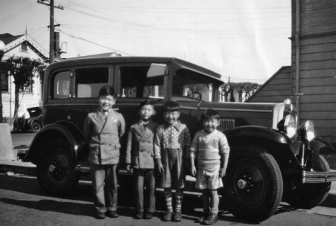 Four young boys standing next to car (ddr-ajah-6-37)