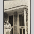 Couple standing outside duplex doorways (ddr-densho-523-172)