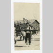 Nisei woman carrying a beam (ddr-csujad-44-50)