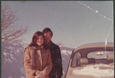 Couple by car in snow (ddr-densho-523-529)