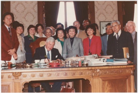 Signing of the Washington State Employees Compensation Bill by Governor John Spellman (ddr-densho-10-162)