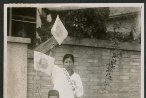 Woman and child waving flags (ddr-densho-359-932)