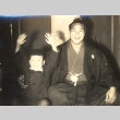Sumo wrestler posing with a boy (ddr-njpa-4-2048)