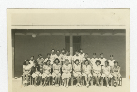Group of Nisei 8th graders with a teacher outside a barrack (ddr-csujad-44-29)