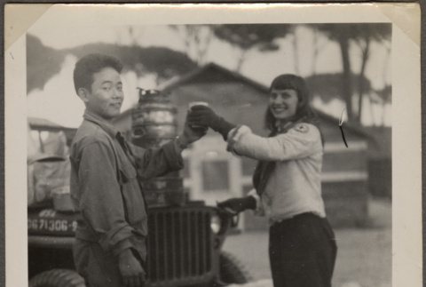 Woman serving coffee to man in uniform (ddr-densho-466-3)