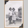 Two women outside a concentration camp barrack (ddr-densho-542-295)