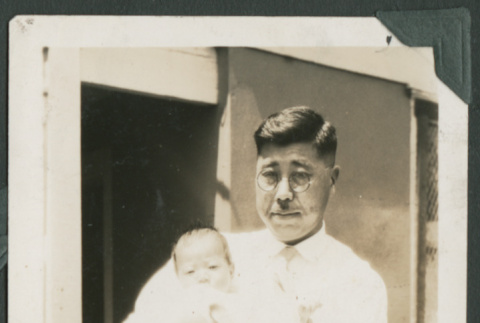 Gentaro Takahashi holding baby (ddr-densho-355-337)