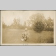 A man and child kneeling in a field (ddr-densho-321-674)