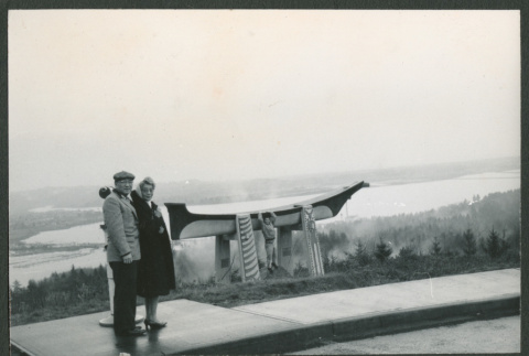 Chester and Agnes Sakura standing by carved canoe (ddr-densho-523-386)