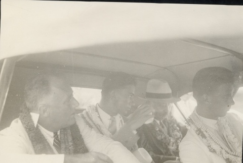 Franklin D. Roosevelt and others sitting in a car wearing leis (ddr-njpa-1-1638)