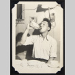 Man drinking from a bottle (ddr-densho-542-759)