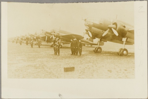 Pilots and ground crew members standing next to their planes (ddr-njpa-13-1115)