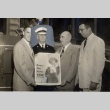 Neal Blaisdell, Samuel Wilder King, fire chief and AmFac manager holding poster (ddr-njpa-2-1166)