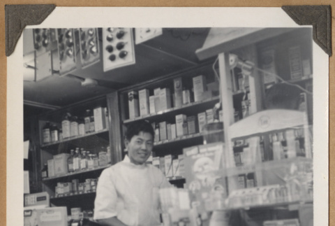 Man behind shop counter (ddr-densho-542-92)