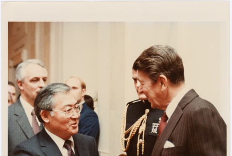 Signed photograph of Frank Sato with former president Ronald Reagan (ddr-densho-345-27)