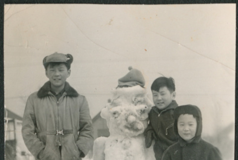 Three boys by snowman (ddr-densho-523-232)